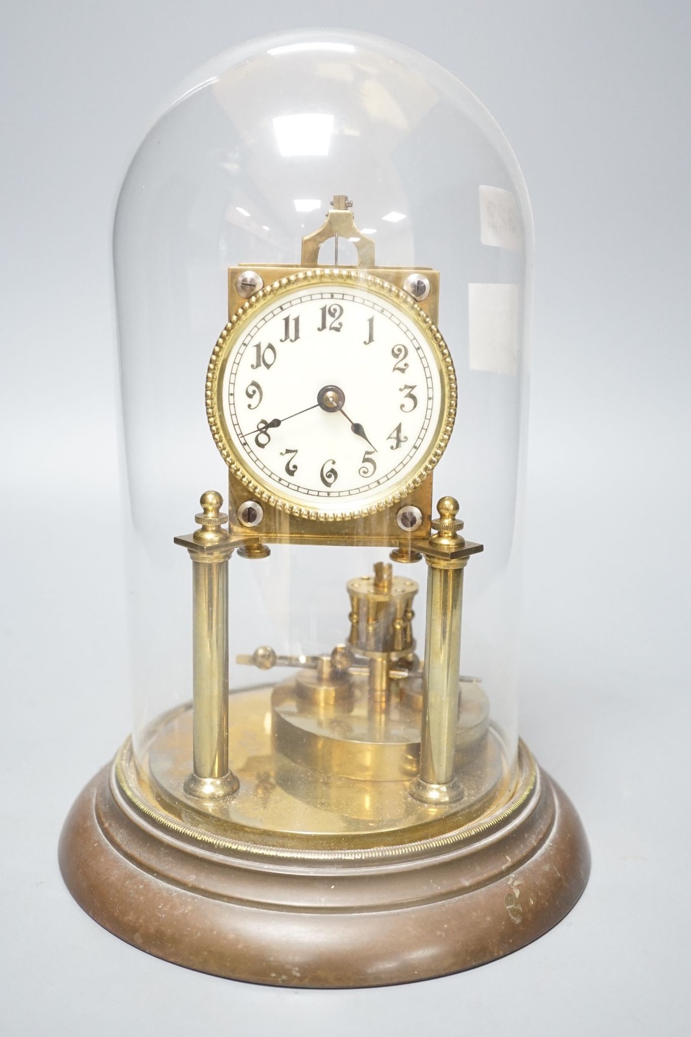 An early 20th century month going mantel timepiece, with a silk suspension, under a glass dome 29cm